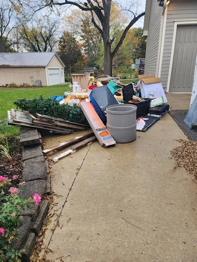 Dumpster being loaded with debris for 12 Yard Dumpster Rental in Pascagoula